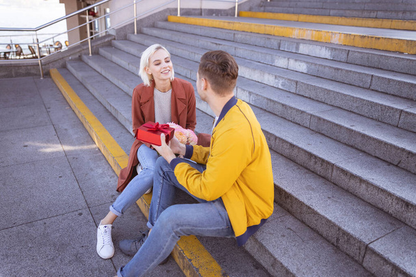Cheerful couple relaxing on the empty stairs - Foto, Imagem