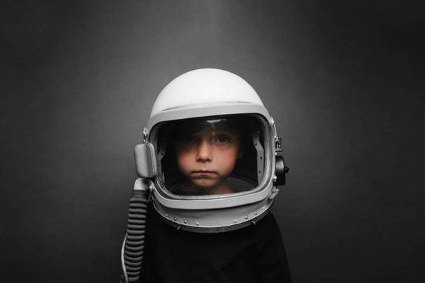 Small child wants to fly an airplane wearing an airplane helmet - Zdjęcie, obraz