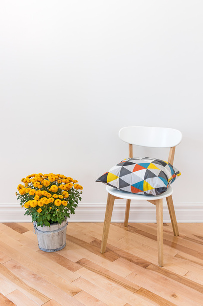 Orange chrysanthemums bright cushion on a chair - Photo, Image