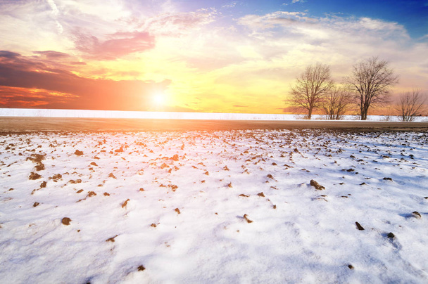 Winter countryside road with snow against sky with sunset - Photo, image