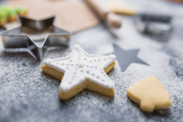 Christmas cookie in form of star with white decoration. Sweet holiday food making concept. - Фото, изображение