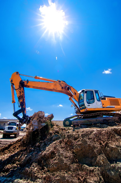 Industrial heavy duty excavator moving earth and soil - Photo, Image