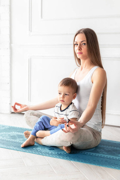 Mom with a Little Kid Goes in for Sports. Sport family. Healthy lifestyle. Yoga. Motherhood. Copy Space - Photo, Image