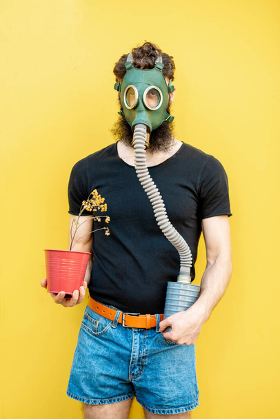Man with gas mask and flowerpot - Photo, Image