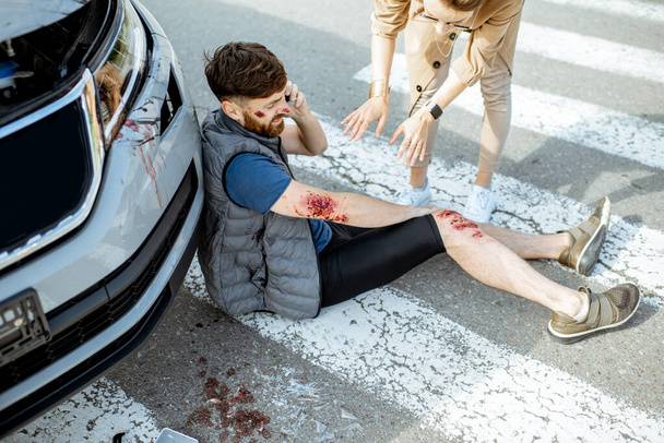 Woman driver with injured man on the road - Photo, Image