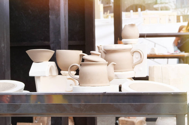 Handmade clay pots after potters wheel. Pottery, and craftsmanship concept. Workshop for handicraft. - 写真・画像