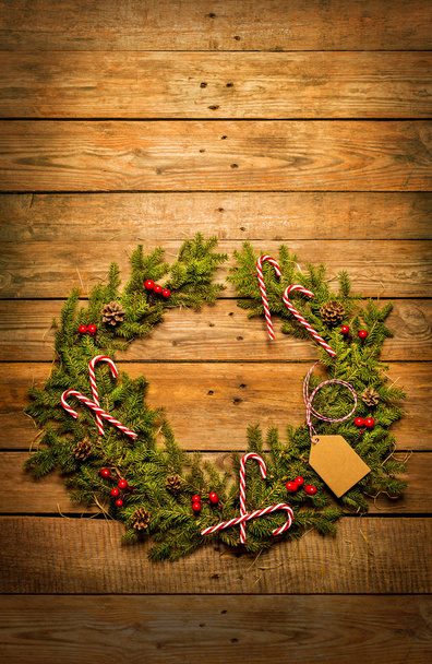 Christmas wreath with decorations on vintage wooden background - Fotoğraf, Görsel