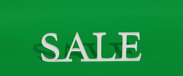 Green Friday concept. Wooden symbol word with text Sale on green backround. Shopping concept - Fotó, kép