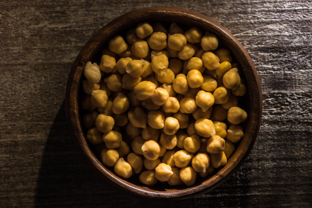 top view of chickpeas in bowl on wooden rustic table - Photo, Image