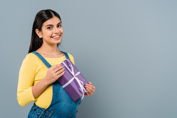 smiling pregnant pretty girl holding present isolated on grey - Φωτογραφία, εικόνα
