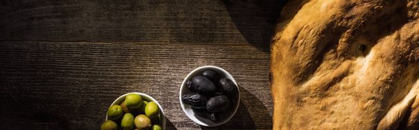top view of delicious pita and olives on wooden rustic table, panoramic shot - Valokuva, kuva