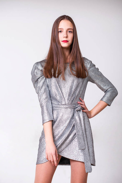 Young beautiful model with a silver stylish dress  - Zdjęcie, obraz
