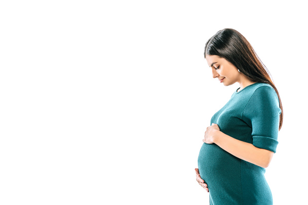 вид збоку усміхнена вагітна дівчина торкається живота ізольовано на білому
 - Фото, зображення