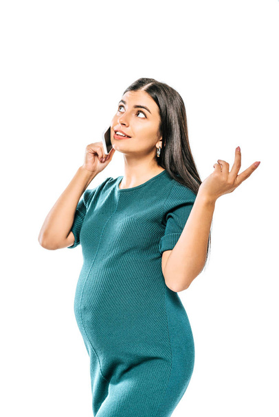 dreamy pregnant girl talking on smartphone isolated on white - Foto, immagini