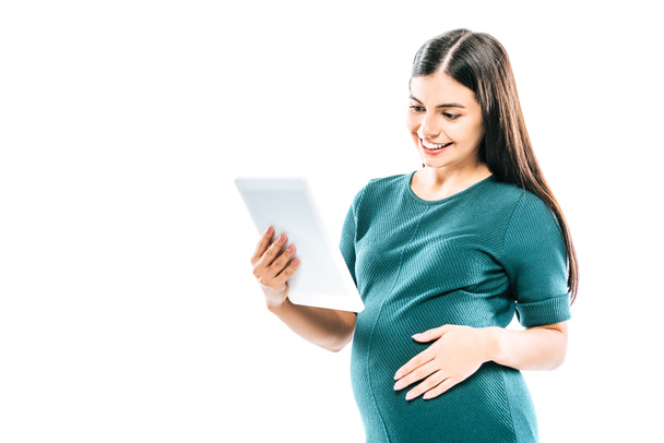 smiling pregnant girl using digital tablet isolated on white - Fotó, kép