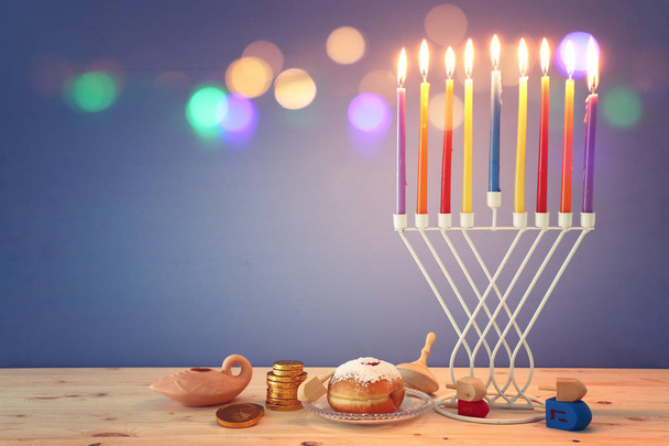 religion image of jewish holiday Hanukkah background with menorah (traditional candelabra), spinning top and doughnut - Foto, afbeelding