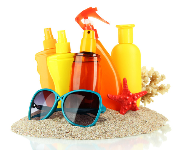 Bottles with suntan cream and sunglasses, isolated on white - Fotó, kép