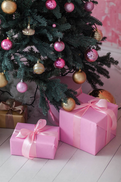 Christmas gift box near the Christmas tree. - Fotoğraf, Görsel