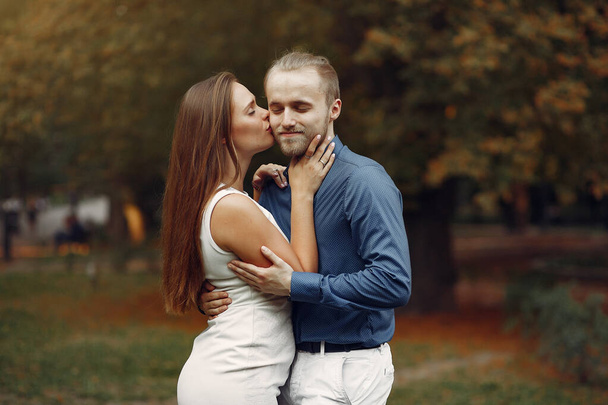 Beautiful couple spend time in a summer park - Фото, изображение