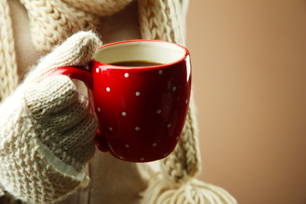 Female hands with hot drink, on color background - Φωτογραφία, εικόνα