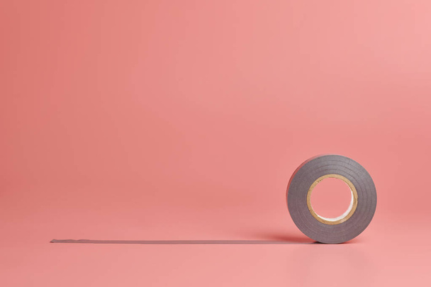 Electrical tape roll, copy space. Minor repairs in house concept. Minimal pink background. - 写真・画像