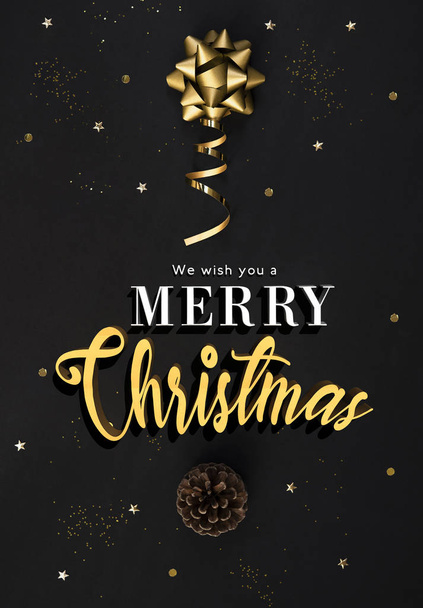 Christmas postcard with decorations gold confetti on black background for christmas and new year concept. - Photo, Image