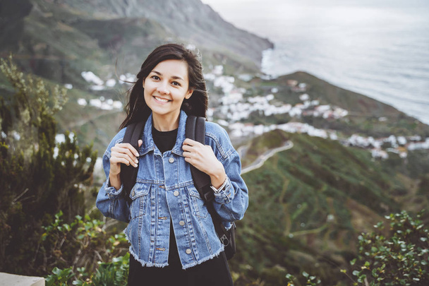 Happy smiling woman with backpack on in the mountains. Travel and lifestyle concept - Foto, imagen