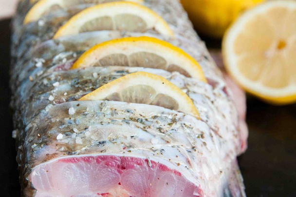 fresh raw fish with lemon - Фото, зображення