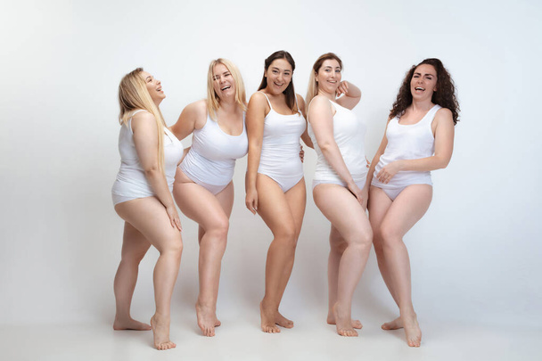 Portrait of beautiful plus size young women posing on white background - 写真・画像