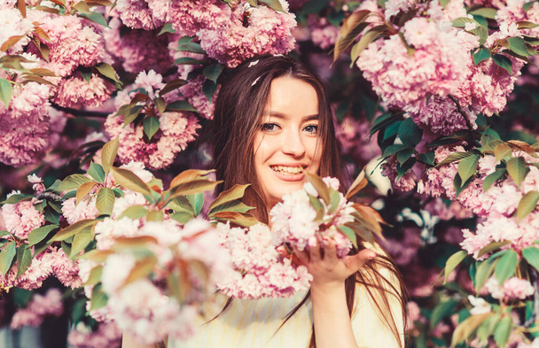 Spring time. blossom smell, allergy. woman in spring flower bloom. girl in cherry flower. Sakura tree blooming. skincare and spa. Natural cosmetics for skin. natural summer beauty - Fotoğraf, Görsel