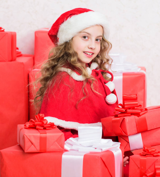 Little santas helper concept. Explore christmas gifts. Unpacking christmas gift. Kid excited about opening christmas present. Girl celebrate christmas. Kid helping santa. New year holiday tradition - Photo, image