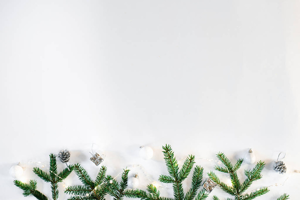 Christmas or new year background, festive composition of Christmas decorations and fir branches, empty space for greeting text, copy space. Postcard - 写真・画像