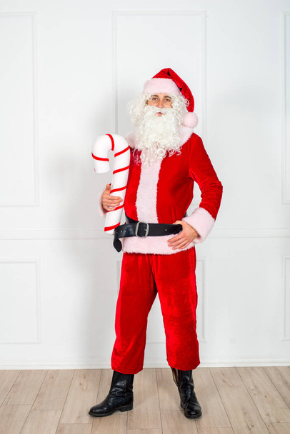 Santa Claus in a classic red suit with a white beard on a white background in studio. Fabulous New Year heroes. Christmas mood. - Foto, imagen