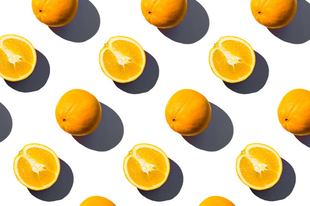 Round oranges on a white background. Sunlight illuminates. - Photo, Image