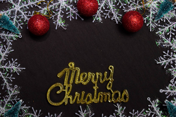 merry christmas text and Decorative Christmas isolated on black background - Photo, Image
