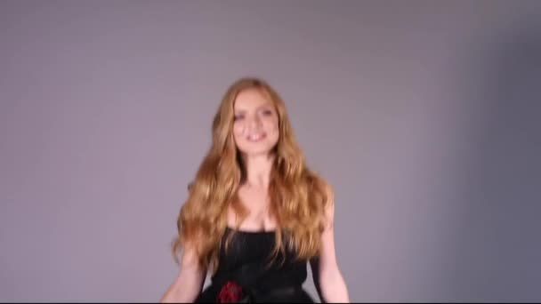 Blonde pretty lady in black dress touching gorgeous curls. - Footage, Video