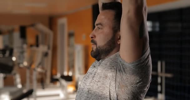 Man lifting dumbbells in a gym making exercise for deltoids - Filmagem, Vídeo