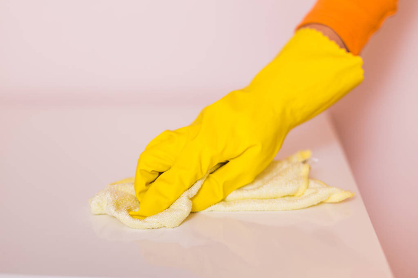 Image of  housewife cleaning table with mop. - Foto, Bild