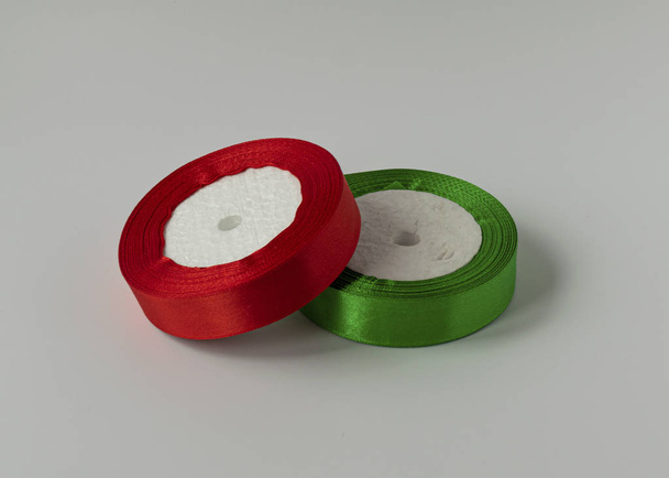A roll of satin ribbon for decorating gifts on a white background. Silk and satin ribbon. - Photo, Image