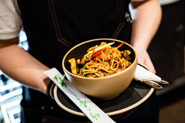chef cooking noodles in the restaurant - Foto, Bild