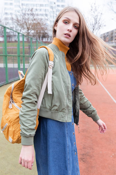 Modern Fashionable Teen Girl on the Football Field. Portrait. Autumn - Fotó, kép