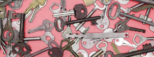 Keys set on pink background. Door lock keys and safes for proper - Фото, зображення