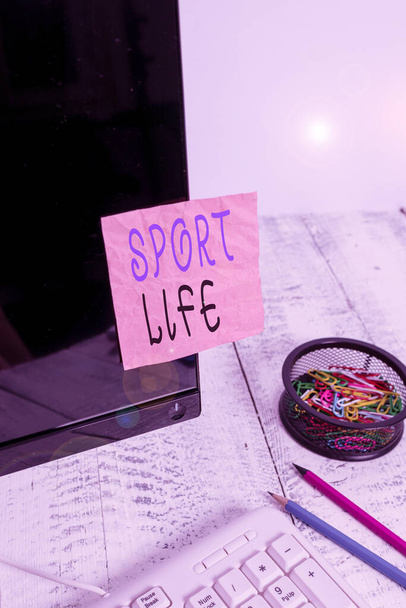 Handwriting text writing Sport Life. Concept meaning Fond of sports or other outdoor activities Physically active Note paper taped to black computer screen near keyboard and stationary. - Photo, Image