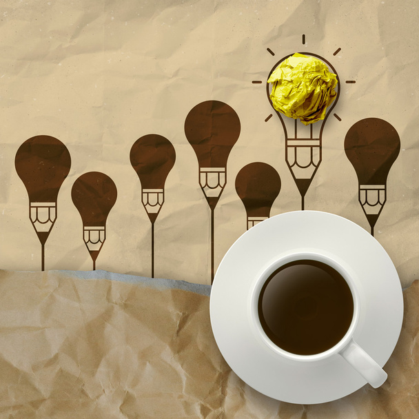 cup of coffee on light bulb crumpled paper and recycle envelope - Φωτογραφία, εικόνα