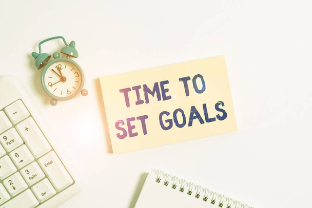 Conceptual hand writing showing Time To Set Goals. Business photo text Desired Objective Wanted to accomplish in the future Keyboard with empty note paper and pencil white background. - Photo, Image