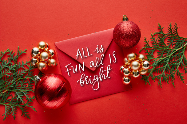 top view of shiny Christmas decoration, envelope with all is fun all is bright illustration and thuja - Fotó, kép