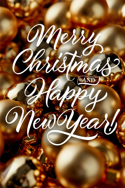 close up view of shiny golden Christmas baubles with merry Christmas and happy New year illustration - Фото, изображение