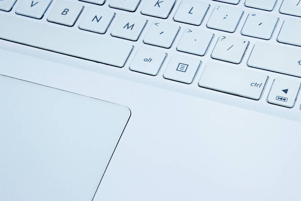 Immagine sfocata di kayboard portatile bianco, da vicino. Laptop, concetto di tecnologia
.  - Foto, immagini