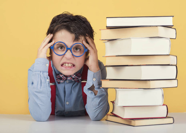 angry child with books - Photo, Image