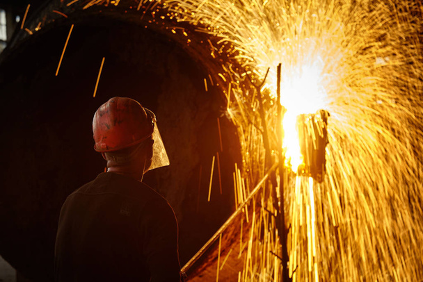 Metallurgist Steelmaker at ingot. Metallurgical production. - Photo, Image